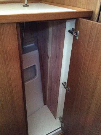 Catalina 425 In Stock Yacht Photos Pics 2024 Catalina 425 interior cabinet with wooden finish and open door.
