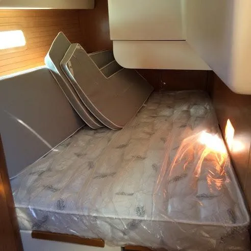 Catalina 425 In Stock Yacht Photos Pics 2024 Catalina 425 interior cabin with mattress and cushions, showcasing cozy sleeping area.