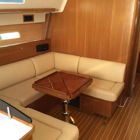 Catalina 425 In Stock Yacht Photos Pics 2024 Catalina 425 yacht interior with beige seating and wooden table.