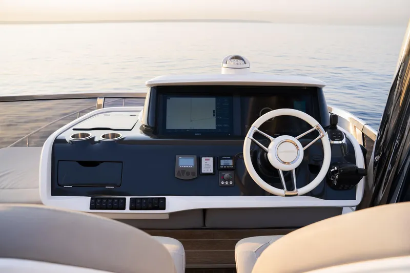 Travitude Yacht Photos Pics Helm of 2020 Pearl 62 yacht with modern controls and ocean view.