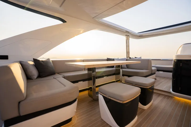 Travitude Yacht Photos Pics Luxurious 2020 Pearl 62 yacht interior with elegant seating and sunset view.