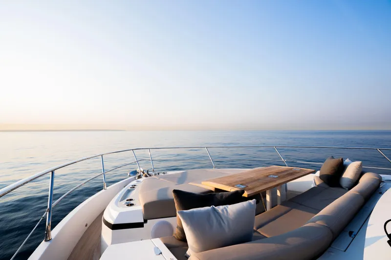 Travitude Yacht Photos Pics Luxurious Pearl 62 yacht deck with elegant seating, overlooking serene ocean, 2020 model.