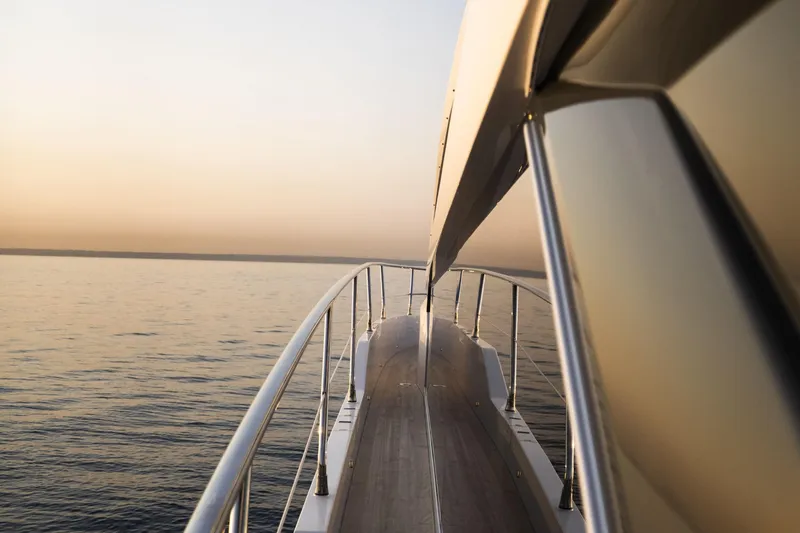 Travitude Yacht Photos Pics Luxurious Pearl 62 yacht deck at sunset, 2020 model, cruising on calm waters.