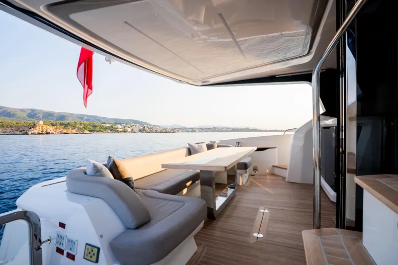 Travitude Yacht Photos Pics Luxurious Pearl 62 yacht deck with elegant seating and scenic ocean view, 2020 model.