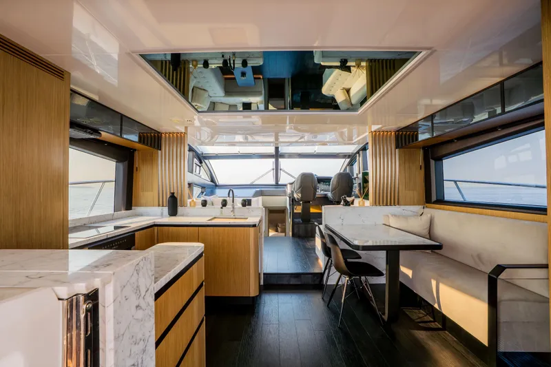Travitude Yacht Photos Pics Luxurious interior of 2020 Pearl 62 yacht with modern kitchen and dining area.