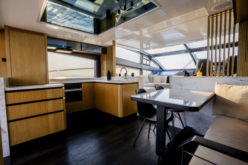 Travitude Yacht Photos Pics Luxurious interior of 2020 Pearl 62 yacht with modern kitchen and dining area.