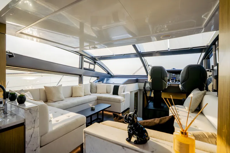 Travitude Yacht Photos Pics Luxurious interior of 2020 Pearl 62 yacht with modern seating and panoramic windows.