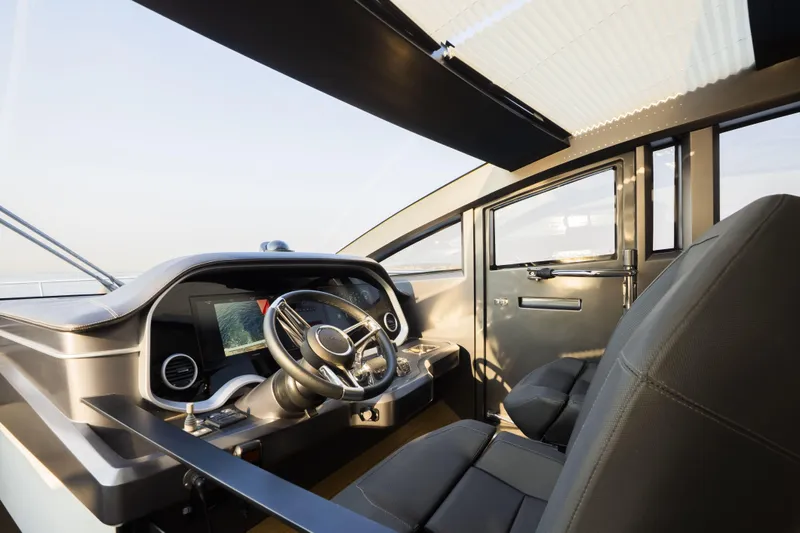 Travitude Yacht Photos Pics Luxurious interior of 2020 Pearl 62 yacht with modern steering and navigation system.