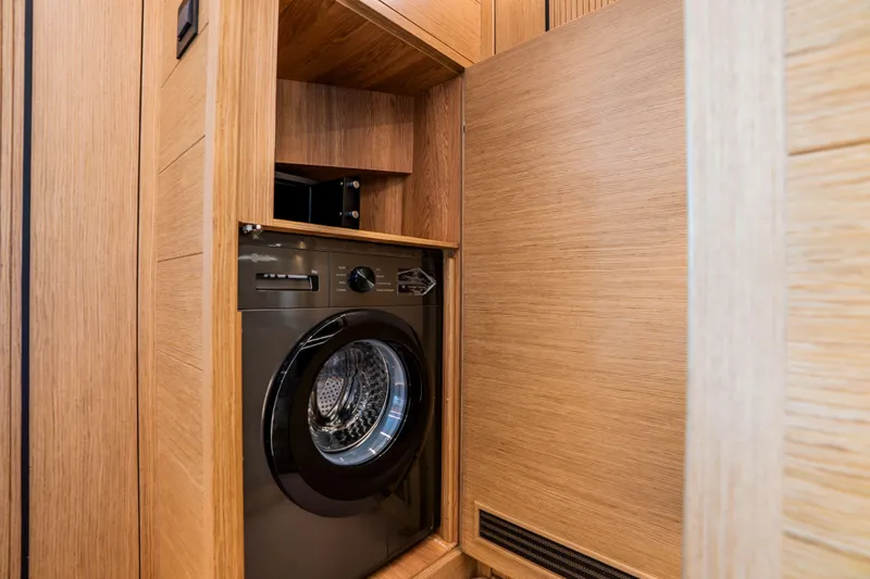 Travitude Yacht Photos Pics Built-in washing machine in wooden cabinet, Pearl 62, 2020 model.