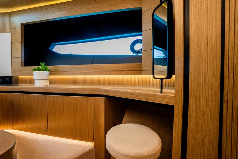 Travitude Yacht Photos Pics Luxurious interior of 2020 Pearl 62 yacht with modern wood finish and ambient lighting.