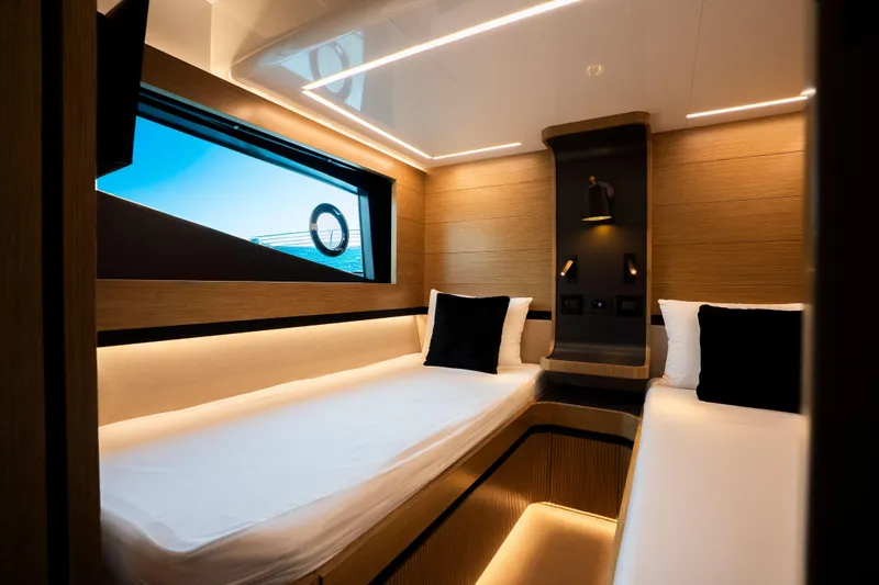 Travitude Yacht Photos Pics Luxurious cabin interior of 2020 Pearl 62 yacht with modern lighting and twin beds.