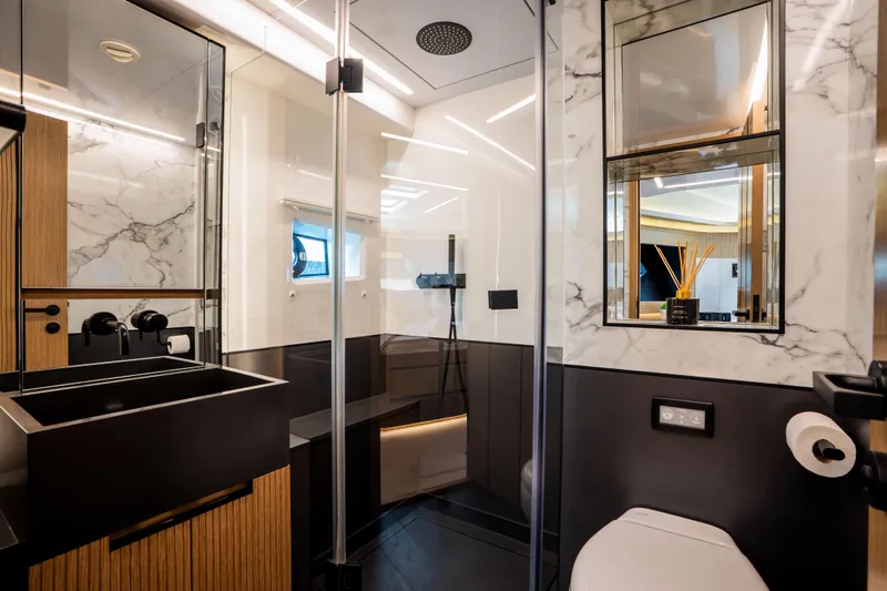 Travitude Yacht Photos Pics Luxurious yacht bathroom with modern fixtures, marble accents, and sleek design, Pearl 62, 2020 model.