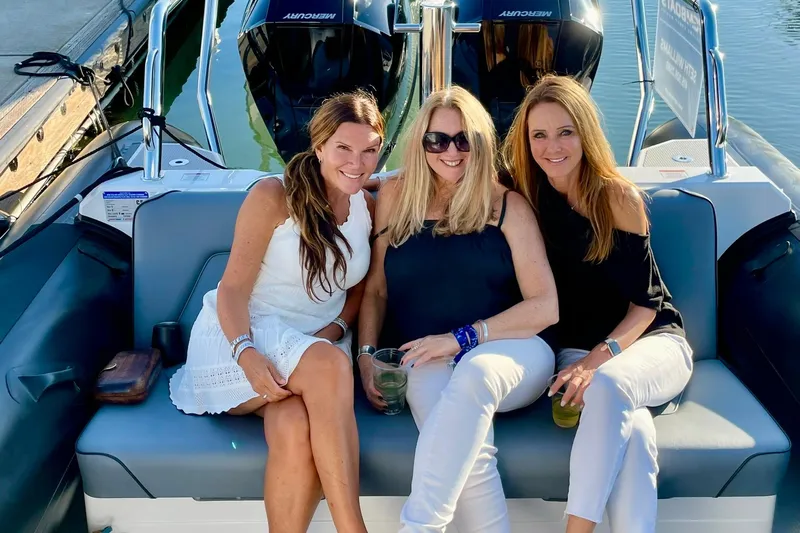  Yacht Photos Pics Three women sitting on a 2024 Protector 310 Targa boat, enjoying a sunny day.