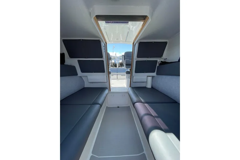  Yacht Photos Pics 2024 Protector 310 Targa interior with seating and storage compartments.