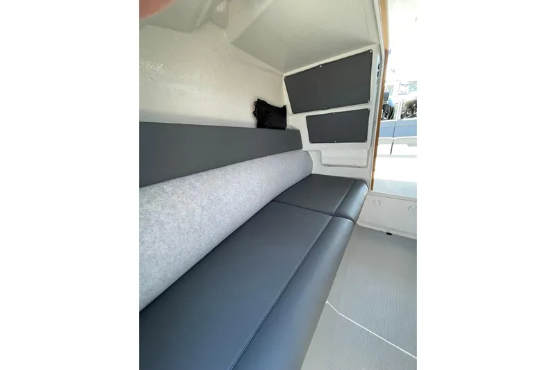  Yacht Photos Pics 2024 Protector 310 Targa interior with gray seating and modern design.