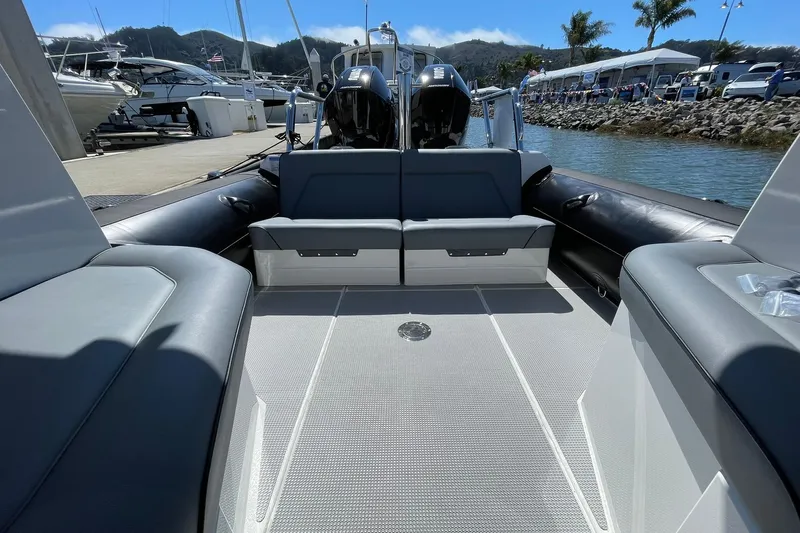  Yacht Photos Pics 2024 Protector 310 Targa boat interior with seating, docked at marina.