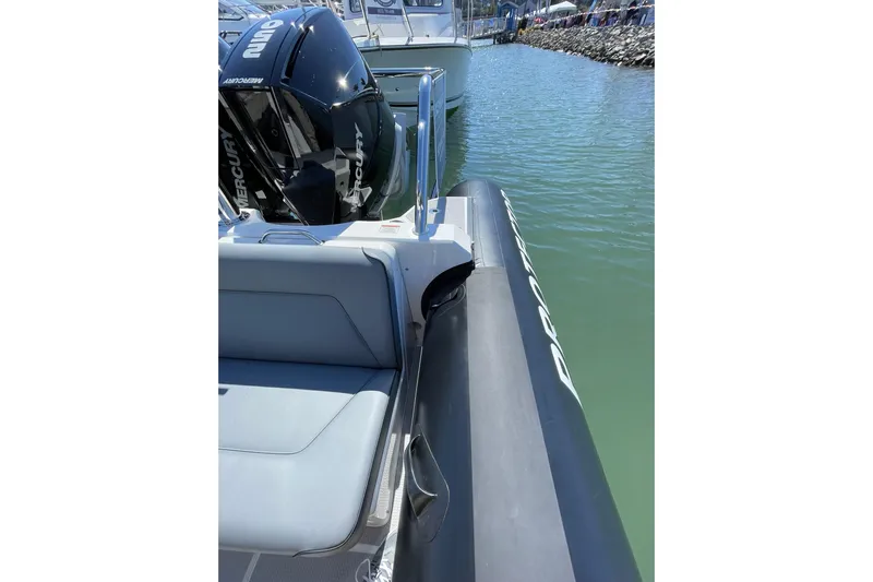  Yacht Photos Pics 2024 Protector 310 Targa boat with Mercury V8 250 HP engine docked in marina.