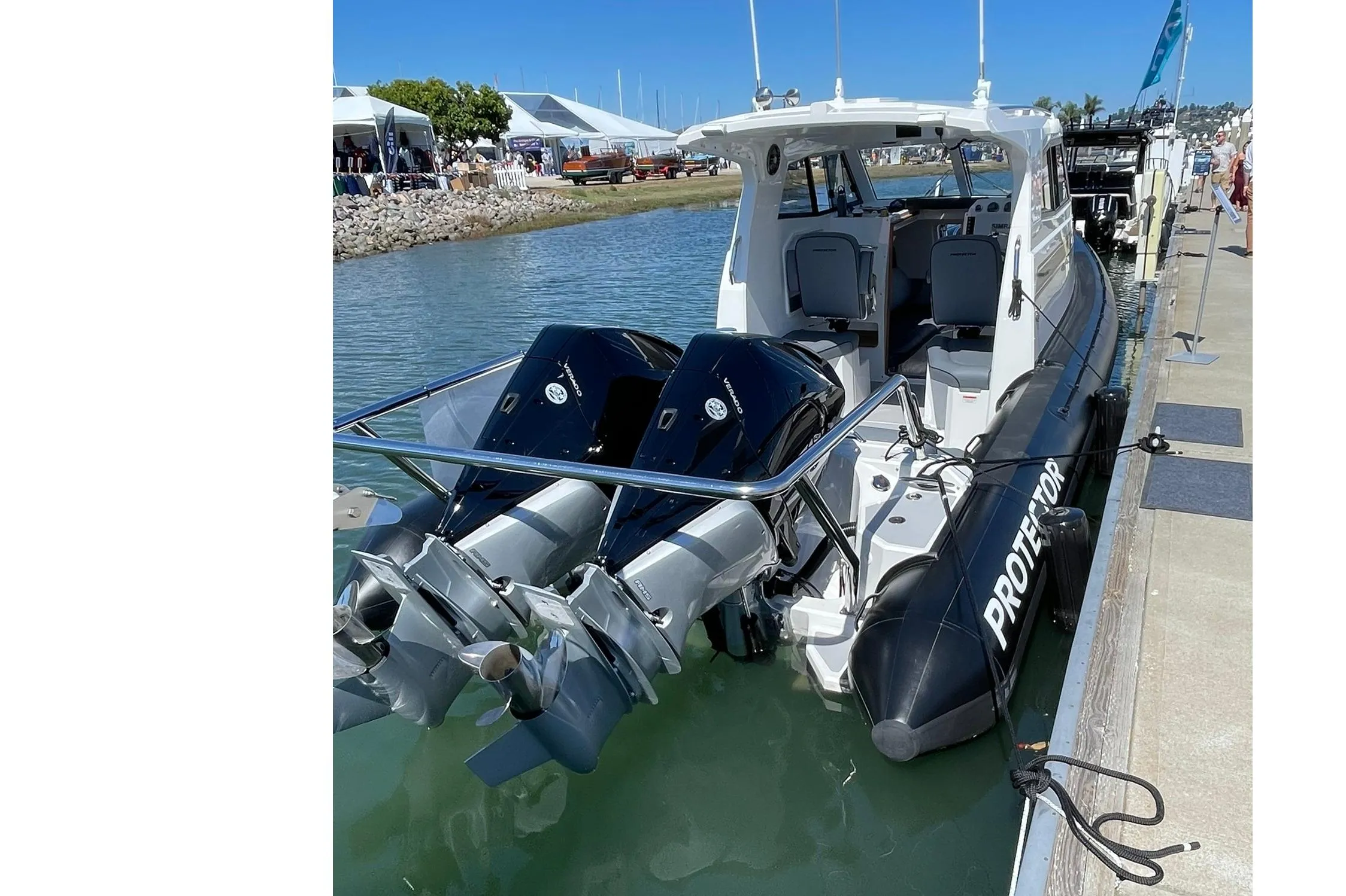2024 Protector 310 Targa boat with dual V8 250 HP engines docked at marina.