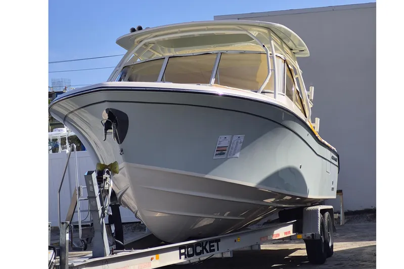 285-662 Yacht Photos Pics 2026 Grady-White Freedom 285 boat on trailer, displayed outdoors.