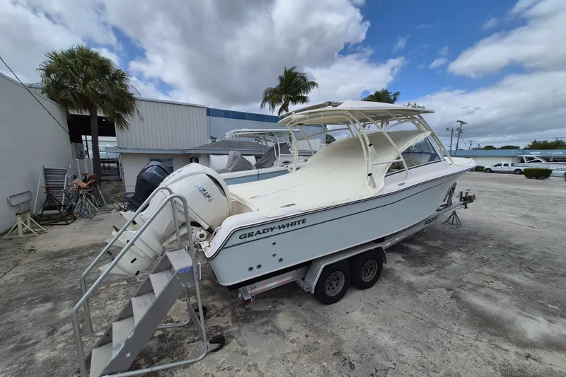285-662 Yacht Photos Pics 2026 Grady-White Freedom 285 boat on trailer, parked outdoors under cloudy sky.