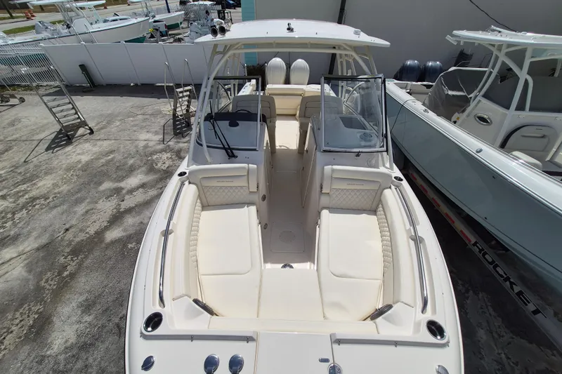 285-662 Yacht Photos Pics 2026 Grady-White Freedom 285 boat with spacious seating and sleek design in a marina.