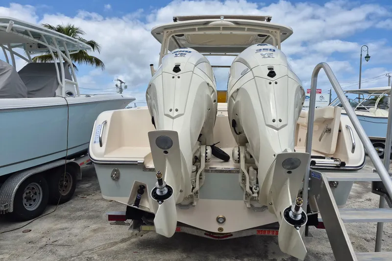285-662 Yacht Photos Pics 2026 Grady-White Freedom 285 boat with dual outboard engines, docked under a blue sky.