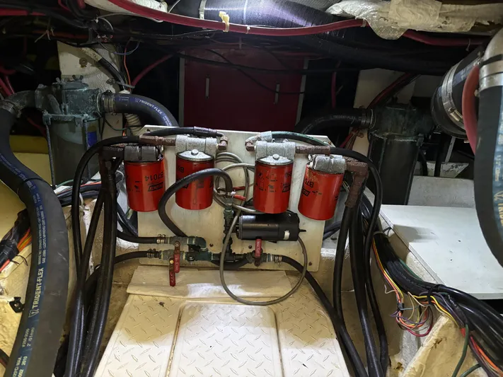  Yacht Photos Pics Engine room of a 1994 Bayliner 4700 with visible filters and hoses.