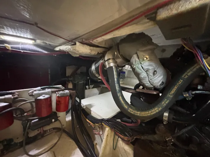  Yacht Photos Pics Engine room of a 1994 Bayliner 4700, showcasing hoses and mechanical components.