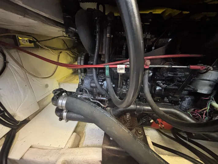  Yacht Photos Pics Engine compartment of a 1994 Bayliner 4700 boat, showcasing hoses and mechanical components.