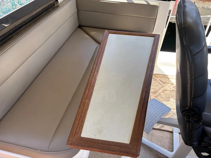  Yacht Photos Pics Interior of 1994 Bayliner 4700 with beige seating and wooden table.