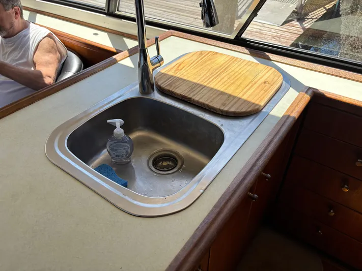  Yacht Photos Pics Kitchen sink area on a 1994 Bayliner 4700 yacht with cutting board and soap dispenser.