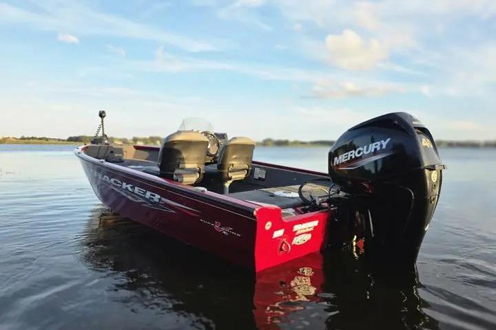 2021 Tracker Super Guide V-16 SC boat with Mercury engine on calm water.