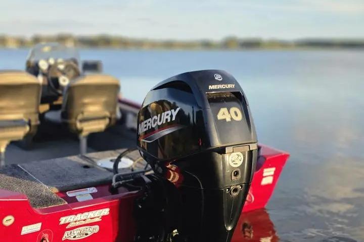 2021 Tracker Super Guide V-16 SC boat with Mercury 40 outboard motor on a lake.