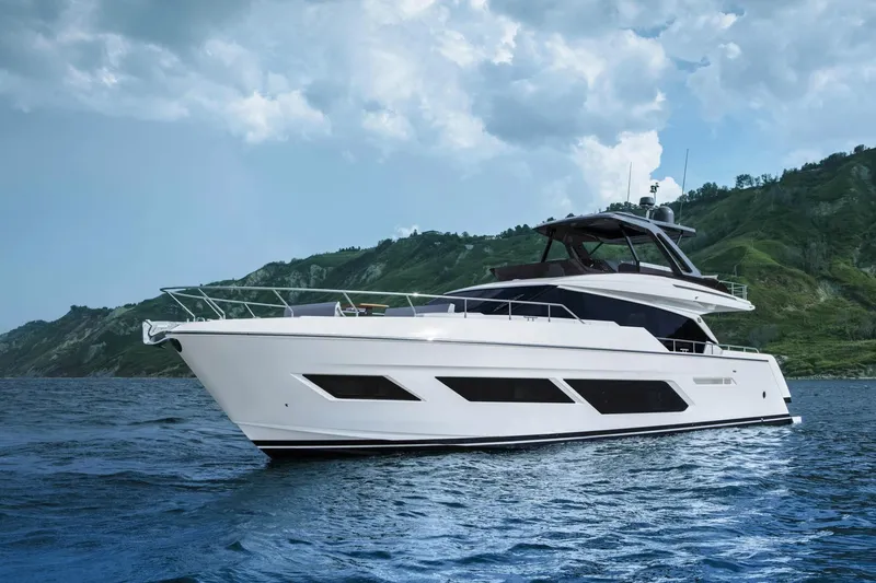  Yacht Photos Pics 2022 Ferretti Yachts 720 cruising on blue waters with scenic green hills in the background.