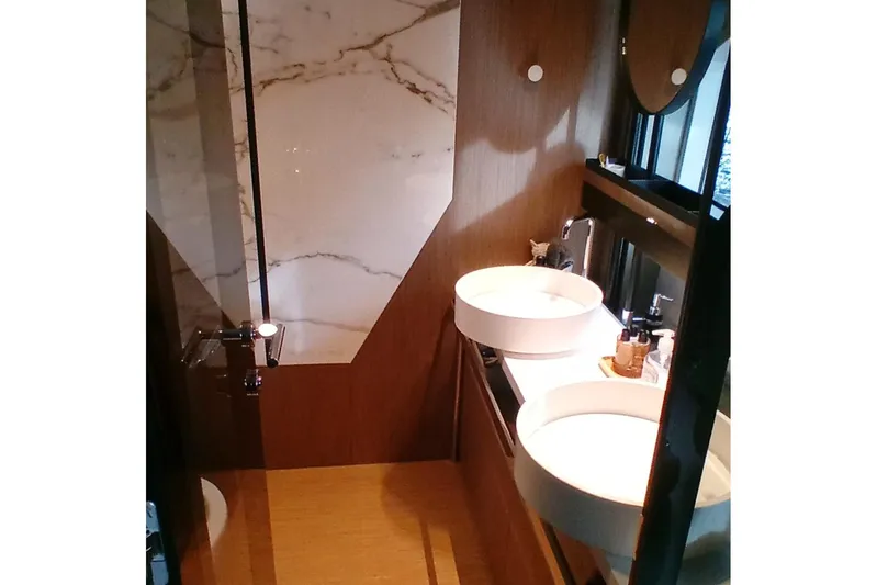  Yacht Photos Pics Luxurious bathroom in 2022 Ferretti Yachts 720, featuring elegant marble and modern fixtures.