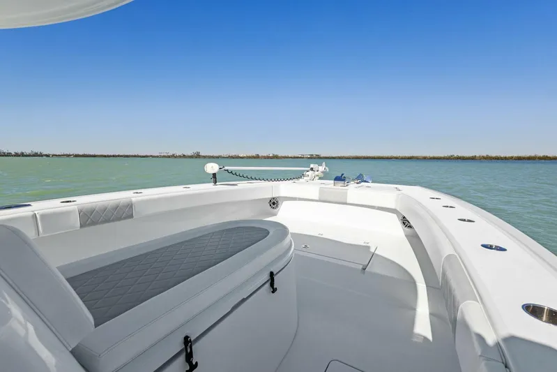  Yacht Photos Pics 2022 Freeman 34VH boat interior with seating, on calm water under clear blue sky.