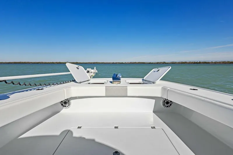  Yacht Photos Pics 2022 Freeman 34VH boat deck with open hatches, on calm water under clear blue sky.