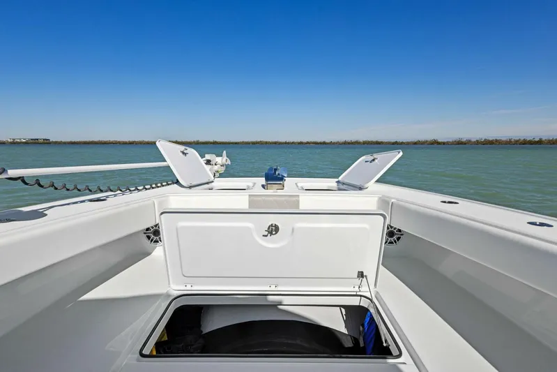  Yacht Photos Pics 2022 Freeman 34VH boat deck with open storage compartments on calm water.