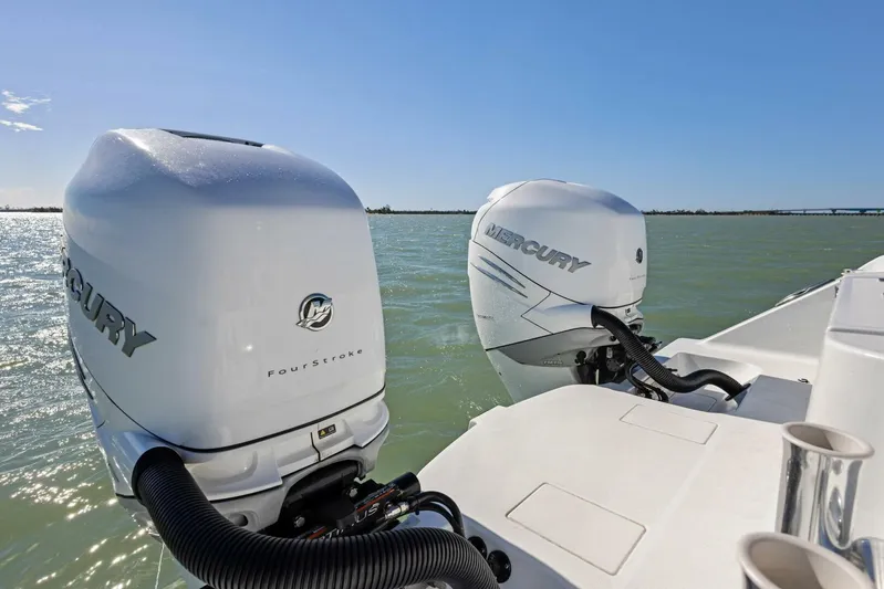  Yacht Photos Pics Twin Mercury outboard engines on a 2022 Freeman 34VH boat in open water.