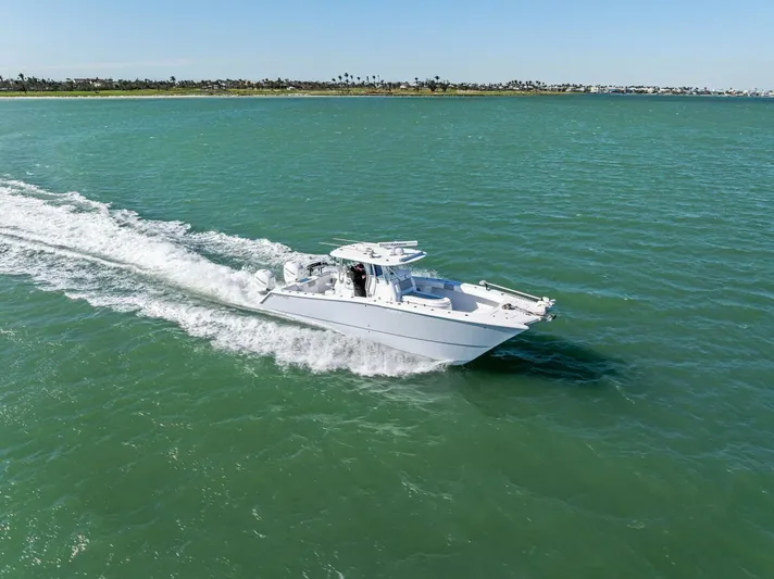  Yacht Photos Pics Freeman 34VH 2022 boat cruising on open water, creating a wake.