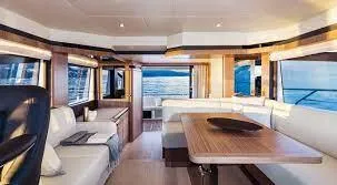 Low Key Yacht Photos Pics Luxurious interior of 2019 Absolute 50 Fly yacht with elegant seating and panoramic windows.