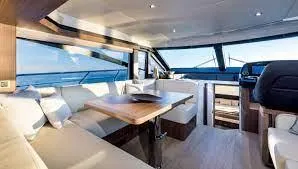 Low Key Yacht Photos Pics Luxurious interior of 2019 Absolute 50 Fly yacht with elegant seating and panoramic windows.
