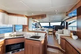 Low Key Yacht Photos Pics Luxurious interior of 2019 Absolute 50 Fly yacht with modern kitchen and seating area.