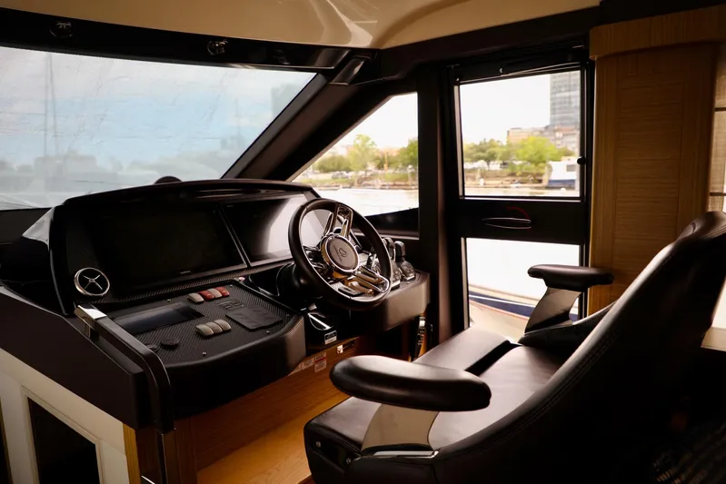 Low Key Yacht Photos Pics Interior cockpit of 2019 Absolute 50 Fly yacht, featuring modern steering and controls.