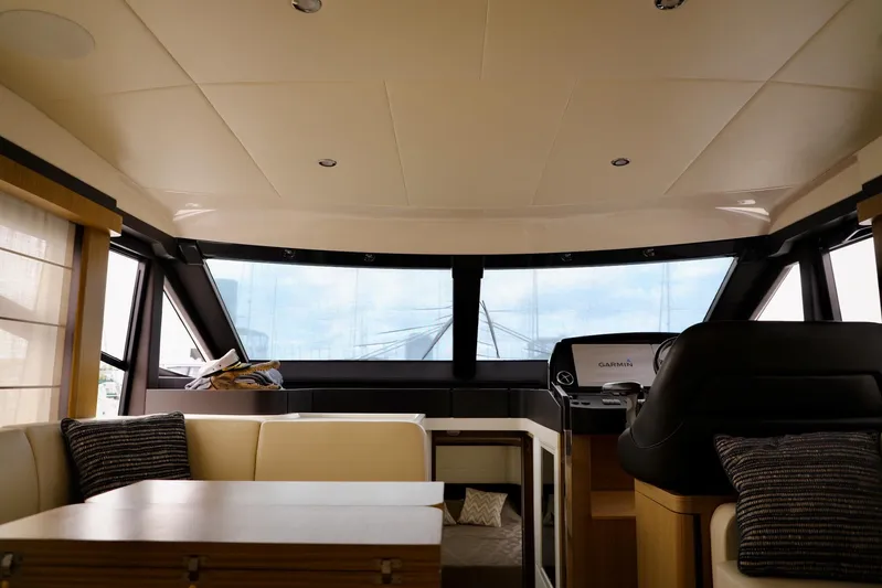 Low Key Yacht Photos Pics Interior of 2019 Absolute 50 Fly yacht, featuring modern seating and helm station.
