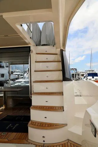 Low Key Yacht Photos Pics Staircase on 2019 Absolute 50 Fly yacht with marina view in background.