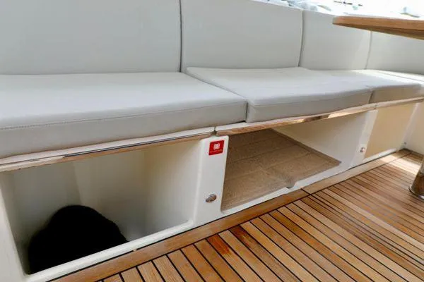 Low Key Yacht Photos Pics Luxurious seating and storage on 2019 Absolute 50 Fly yacht with wooden flooring.