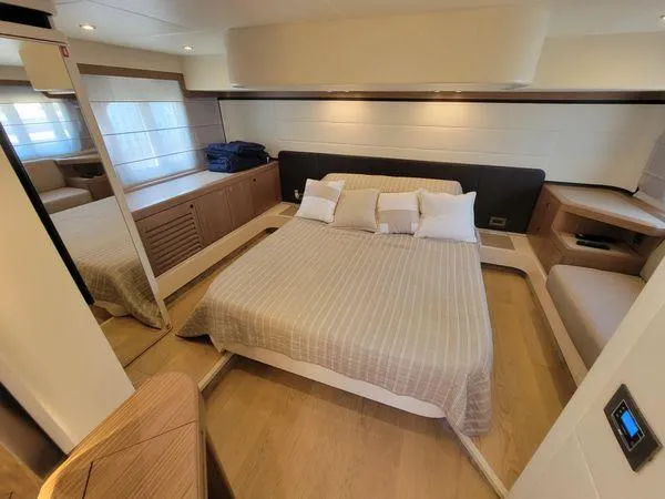 Low Key Yacht Photos Pics Luxurious bedroom interior of 2019 Absolute 50 Fly yacht with modern design and cozy bedding.