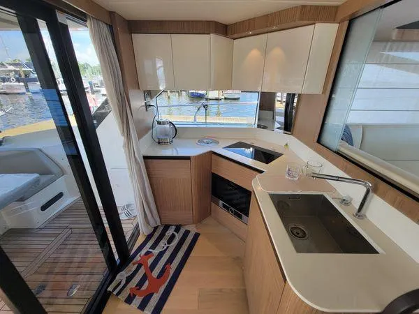 Low Key Yacht Photos Pics Modern kitchen interior on 2019 Absolute 50 Fly yacht, featuring sleek design and marina view.