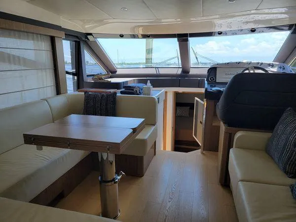 Low Key Yacht Photos Pics Luxurious interior of a 2019 Absolute 50 Fly yacht with modern seating and navigation area.